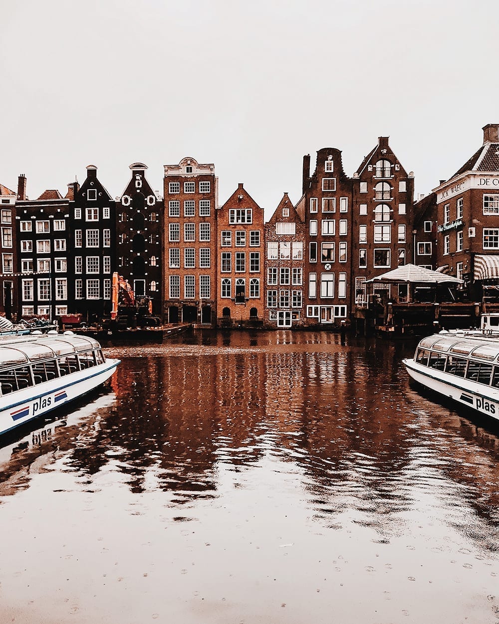 Typical dutch canal houses in Amsterdam reflected in water 